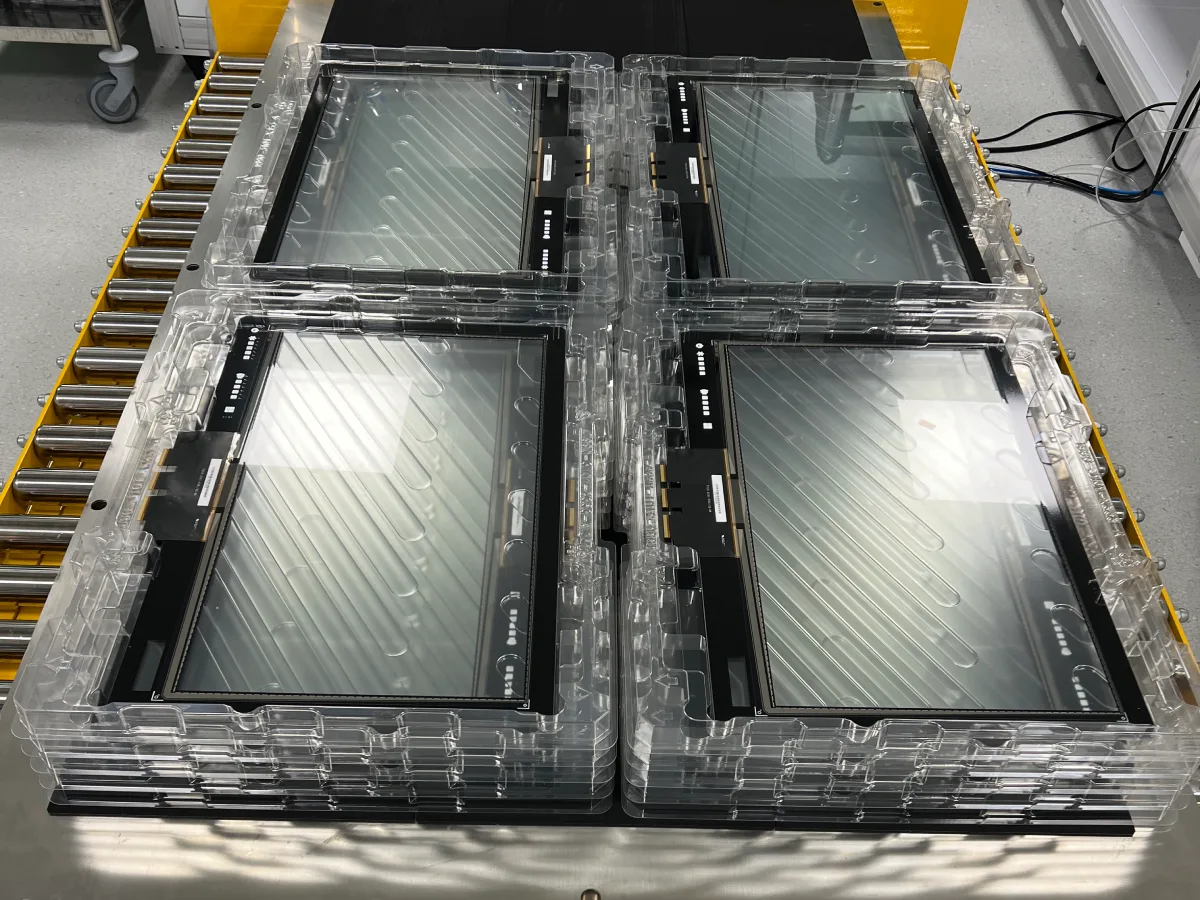 Bonded display assemblies in production trays, ready for integration