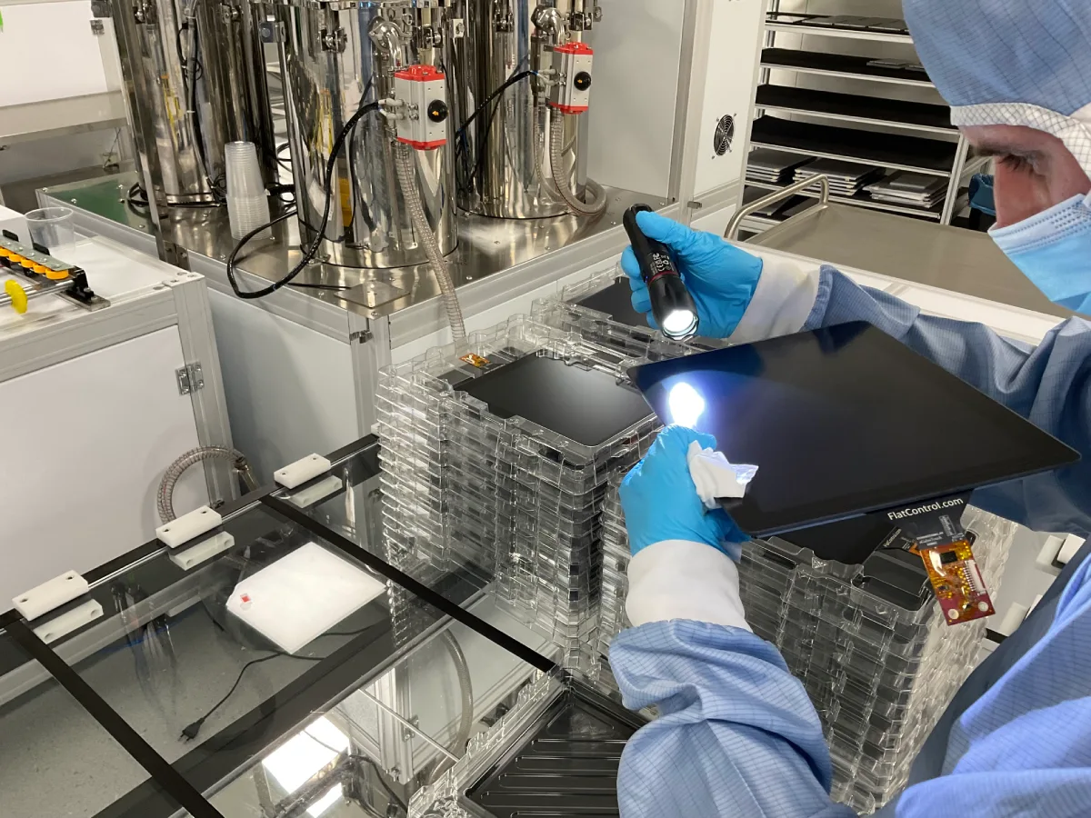 Technician performing a cosmetic inspection of a bonded panel with a flashlight