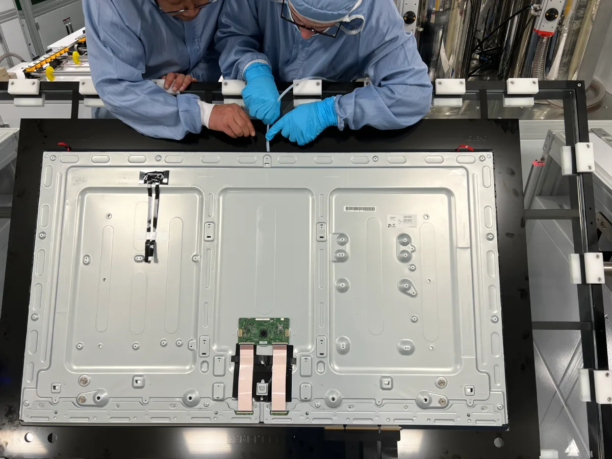 Technicians assembling a large industrial display panel